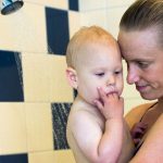 Donna Volmer in the shower with her baby Arlen