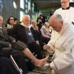 Pope Francis touching the feet of patients