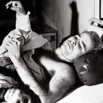 John McCain lies in a hospital bed in Hanoi, North Vietnam, after being taken