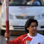 Pakistani Singer Shehzad Roy Holds the Olympic Torch as he runs around the Sports Complex Beijing 2008-