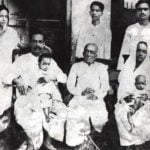 A. C. Bhaktivedanta Swami Prabhupada With His Family (1924), From Left His Wife Radharani (Standing), Swami Prabhupada (Sitting with His Son Prayag Raj), His Father Gaur Mohan De (Sitting), His Nephew Tulsi (Standing, Backside of Gaur Mohan De), His Sister Rajesvari With His Daughter Sulakshman (Sitting), His Brother Krishna Charan (Standing)   