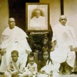 C.	 A. C. Bhaktivedanta Swami Prabhupada’s Family, From Left Swami Prabhupada (Sitting), Portrait of His Father Gaur Mohan De (Middle), His Brother Krishna Charan (Sitting), His Son Prayag Raj (Sitting Frontside Left), His Second Son (Sitting Middle), His Daughter Sulakshman (Sitting Frontside Right)   