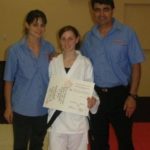 Jessica Bratich Johnson presenting Karate certificate to one of her students, with her father