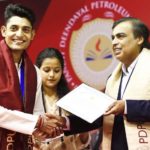 Vidit Sharma receiving merit certificate from Mukesh Ambani