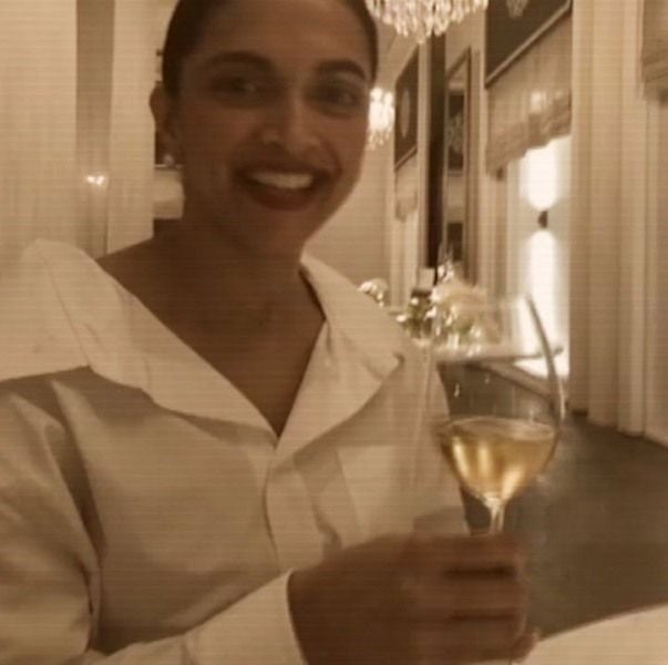 Deepika Padukone holding a glass of wine
