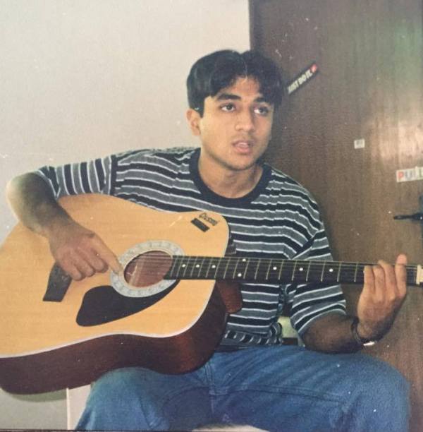 A picture of Vir Das playing the guitar in his college days