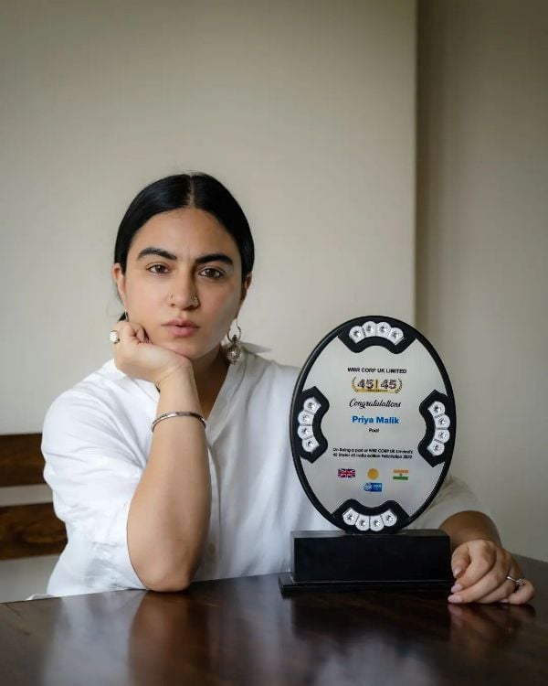 Priya Malik posing with her award for being featured in the World Business Review Corporation UK Ltd's 45 under 45 India list