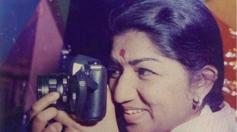 Lata Mangeshkar posing with a camera