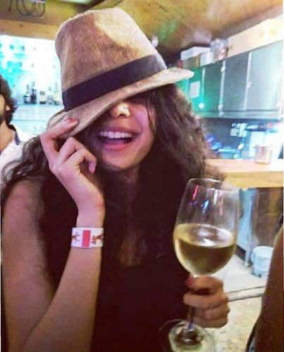 Mithila Palkar with a glass of alcohol