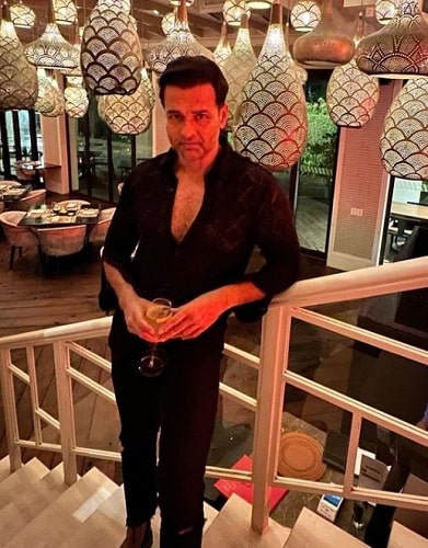 Rohit Roy holding a glass of alcohol