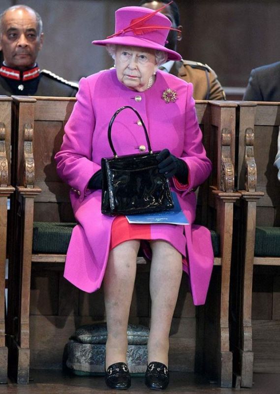 Queen Elizabeth II with her signature handbag at St Mary's Church in London