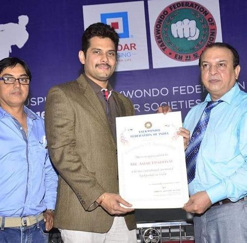 Amar Upadhyay receiving a certificate in taekwondo