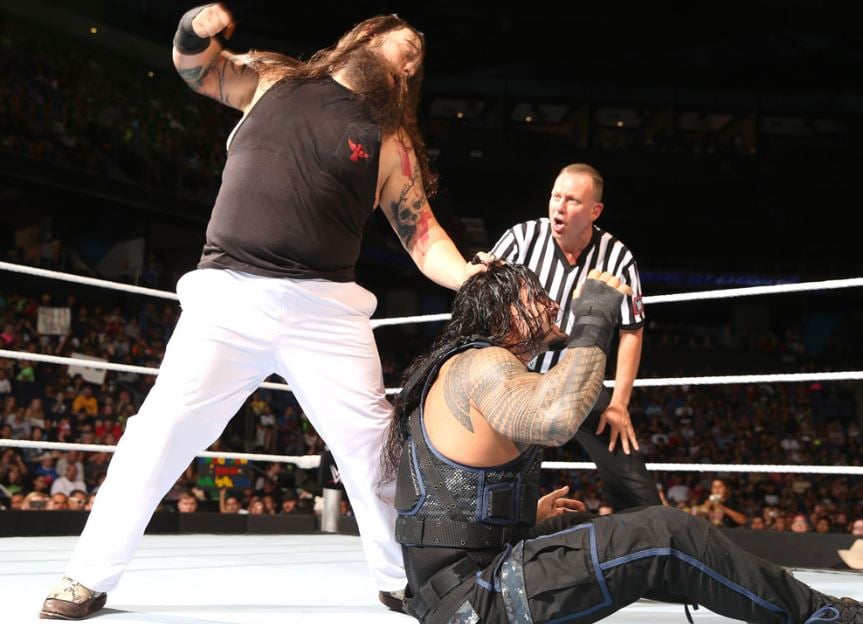 Bray Wyatt (standing) with Roman Reigns
