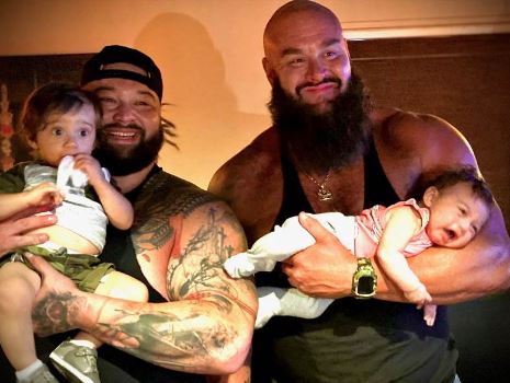 Bray Wyatt with his children and Braun Strowman (right)