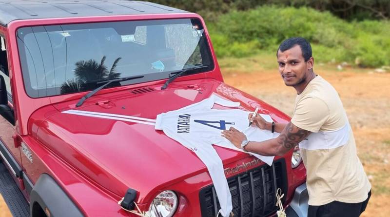 T. Natarajan signing his Gabba Test jersey on the bonnet of the Mahindra Thar SUV gifted by Anand Mahindra