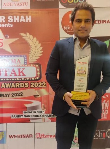 Deepesh Bhan holding his award