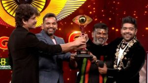 L. V. Revanth (right) posing with his trophy after winning the Telugu version of the Indian reality show Bigg Boss season 6 (2022) on Star Maa