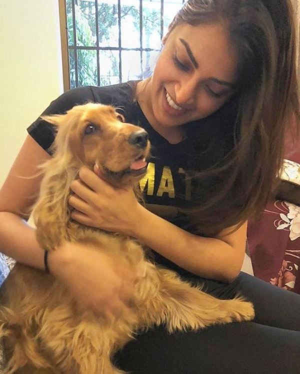 Anushka Ranjan holding her pet dog