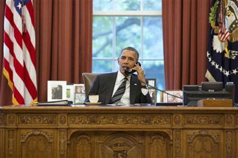 U.S. President Barack Obama talks with Iranian President Hassan Rouhani during a phone call in the Oval Office at the White House in Washington September 27, 2013