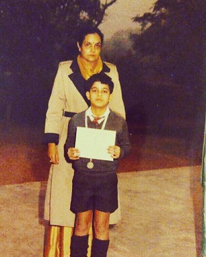 Gautam Rode receiving first prize in the 100m race at his school