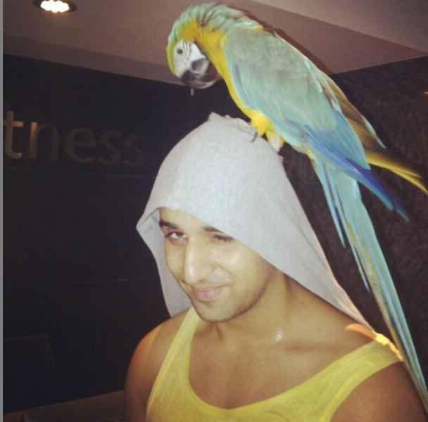 Arslan Goni with his pet parrot