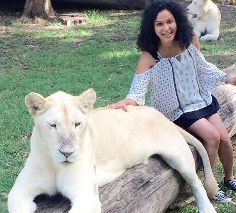 Neetha cuddling a lion during one of her travels