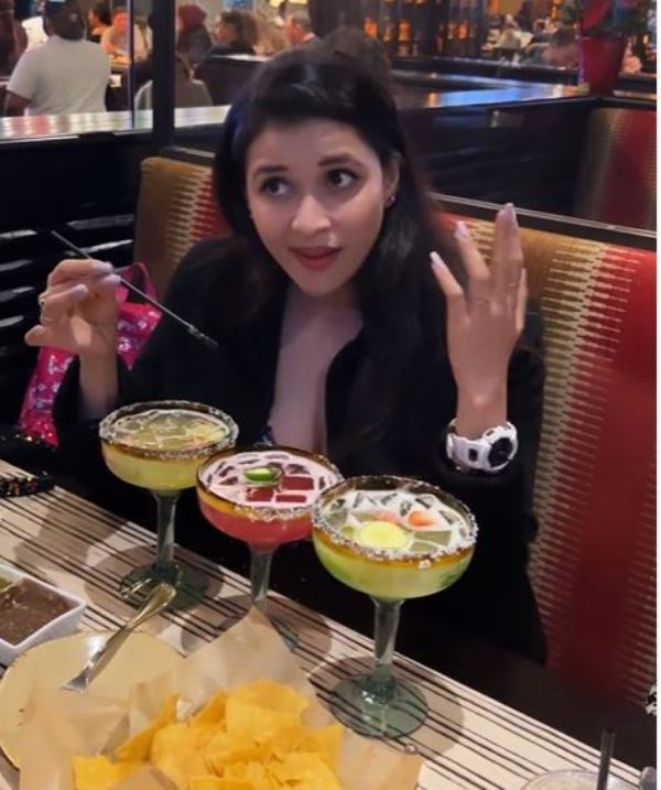Mannara Chopra while tasting margarita