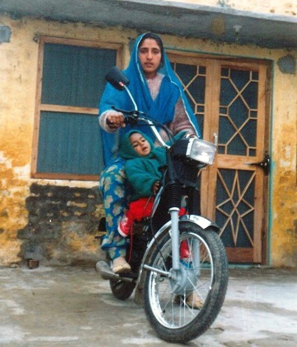Rupi Kaur and her mother riding a bike in the 90s