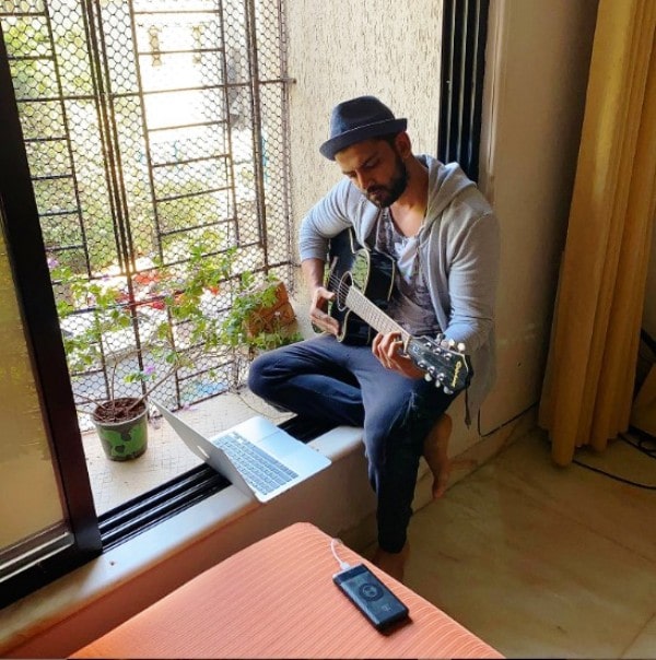 Zaheer Iqbal playing the guitar