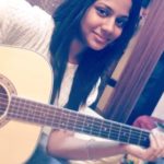 Aishwarya Dutta playing guitar