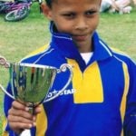 Dele Alli holding a trophy in his childhood
