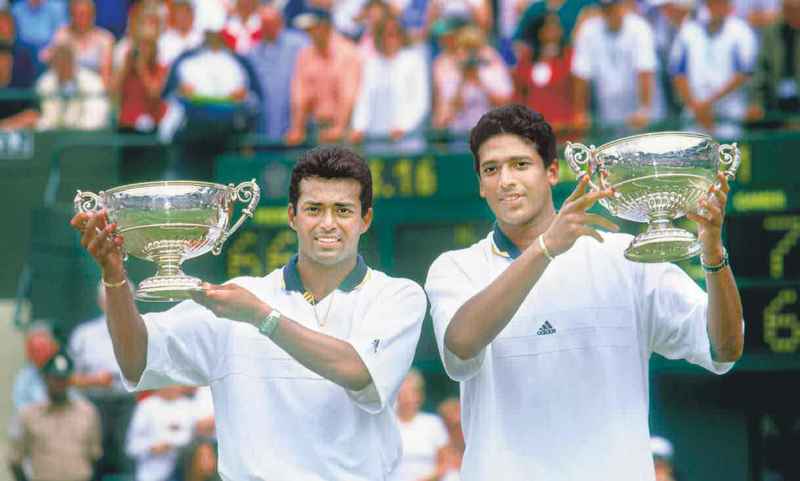 Leander Paes and Mahesh Bhupathi holding the Wimbledon 1999 cup