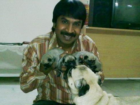Srinivasa Reddy playing with dogs