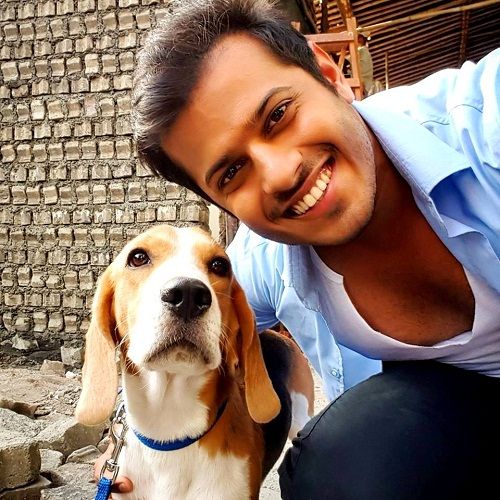 Neil Bhatt posing with his pet dog