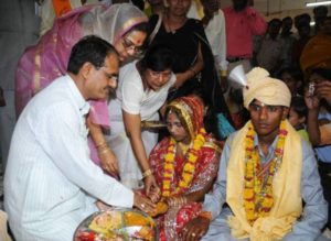 Sadhna Singh with her husband performing rituals during a mass marriage event
