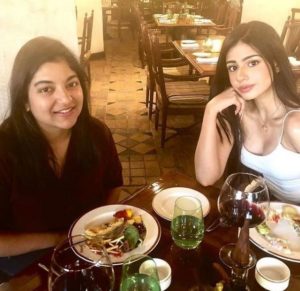 Sarah Khatri drinking wine with her friend
