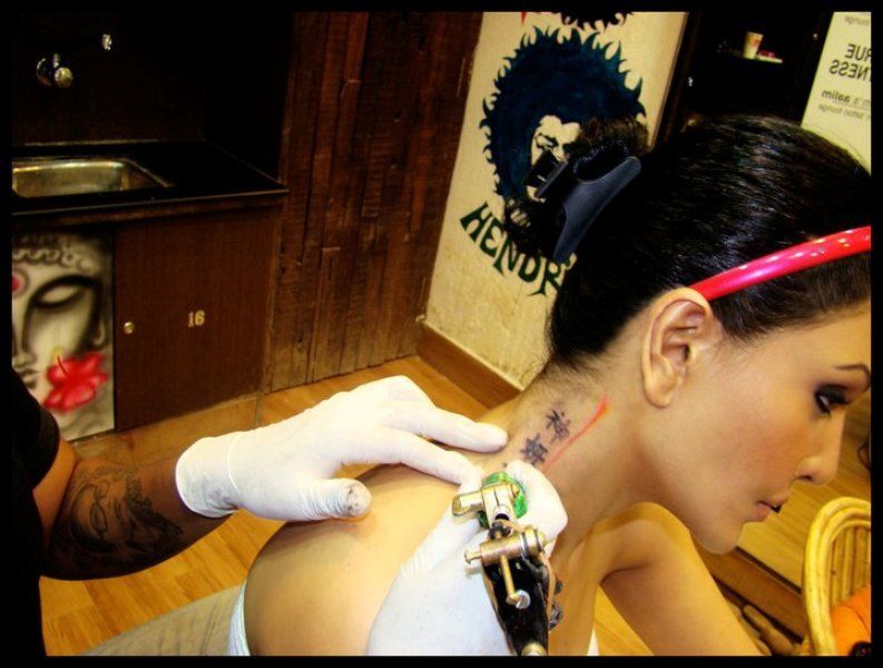 Koena Mitra getting tattooed