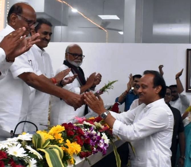 Ajit Pawar wishing Sharad Pawar while other senior NCP leaders are looking