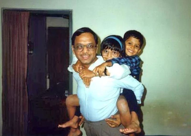 A childhood image of Akshata Murty with her father and younger brother