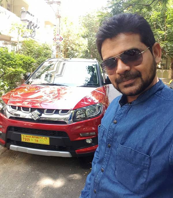Jogi Naidu posing in front of hir Car