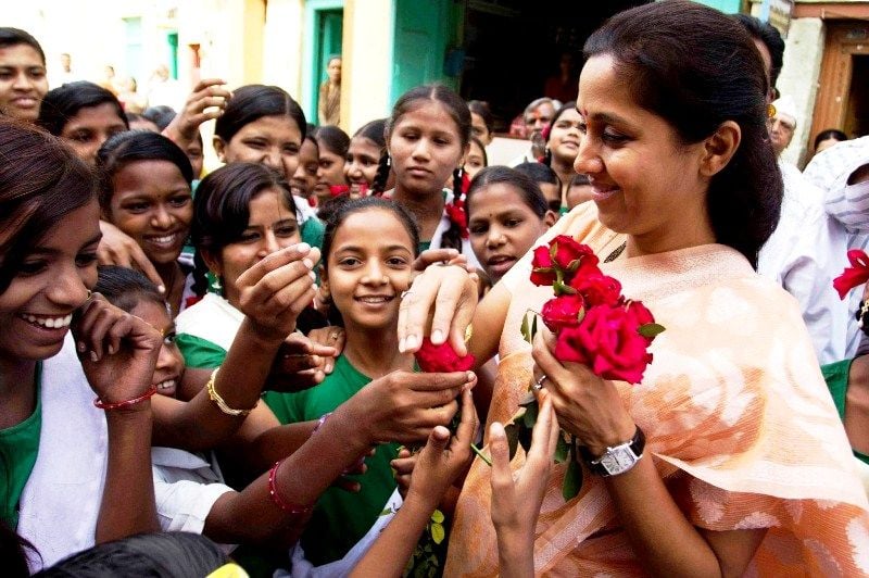 Supriya Sule being greeted by children before an awareness campaign on female foeticide