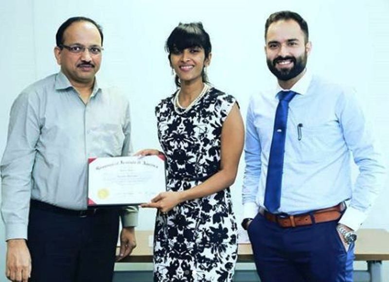 Reshma Rajan Receiving Graduation Certificate