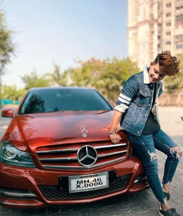 Riyaz Aly Posing with His Car