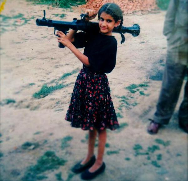 Tania Shergill in her childhood holding an artillery gun