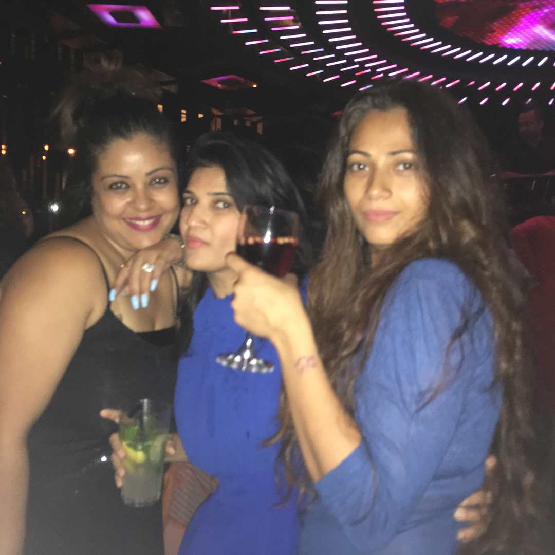 Aaliya Siddiqui holding a glass of alcohol
