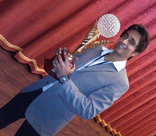 Pradeep Bhandari holding an award