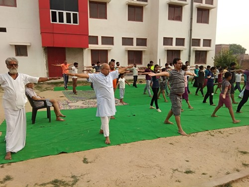 H. C. Verma doing yoga at a local school