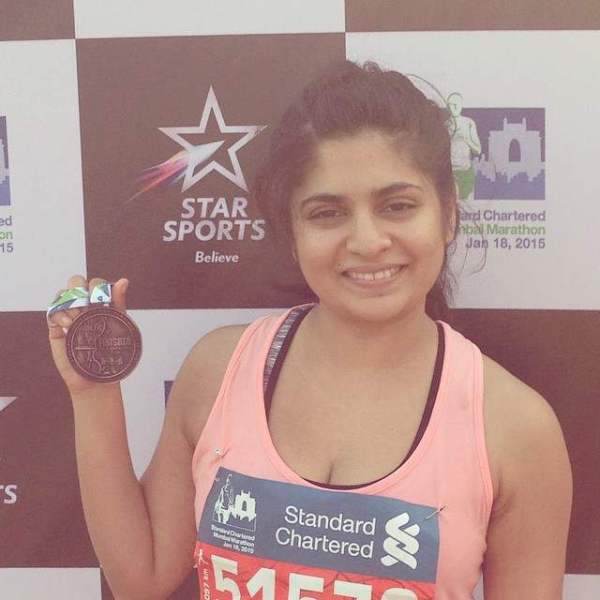 Sandhya Shekar with medal for completing half marathon in 2015