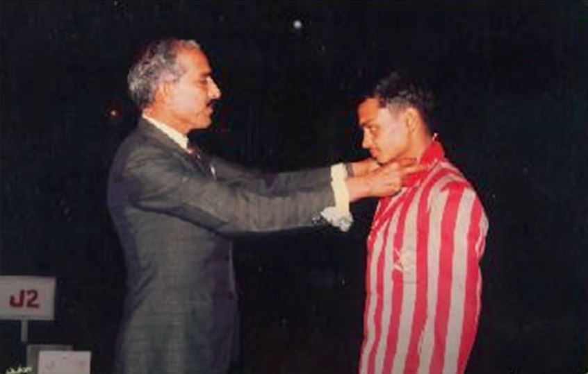 Sengar receiving gold medal in a platform diving competition held among the students of his NDA batch