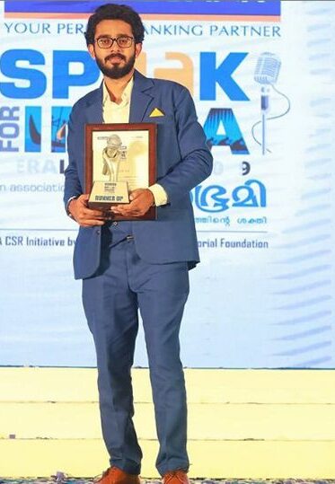 Adoney John with his award at Federal Bank Speak for India competition